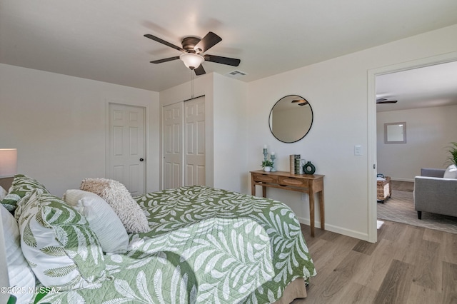 bedroom featuring light wood-type flooring and ceiling fan