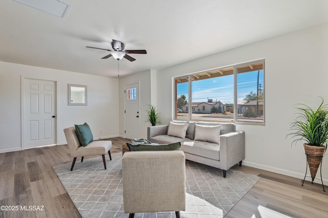 living room with ceiling fan and light hardwood / wood-style flooring