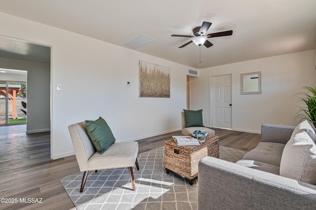 living room featuring wood-type flooring and ceiling fan