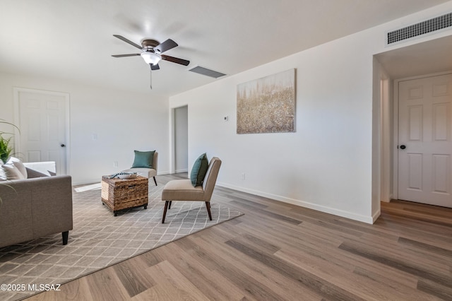 living area featuring ceiling fan and light hardwood / wood-style floors