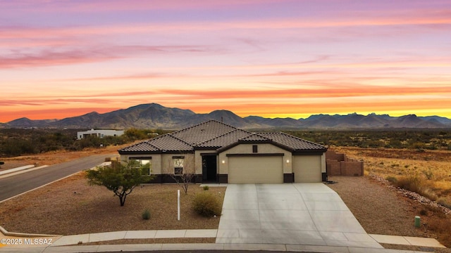 view of front of home featuring a mountain view and a garage