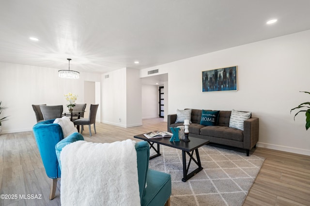 living room featuring wood-type flooring and a chandelier