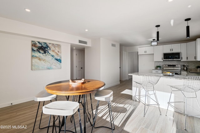 dining space featuring light hardwood / wood-style floors