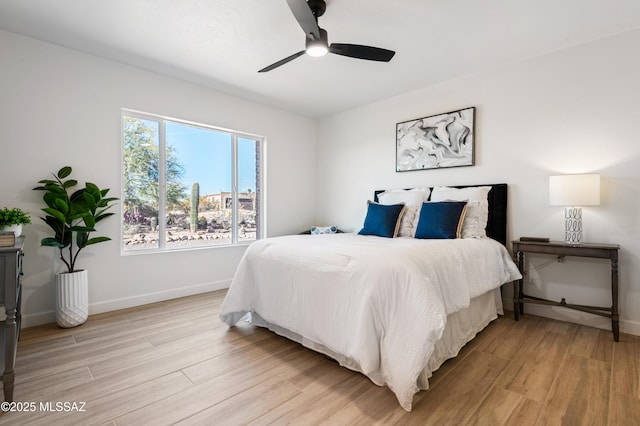 bedroom with light wood-type flooring and ceiling fan