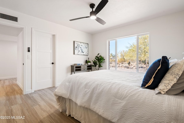 bedroom with ceiling fan and light wood-type flooring