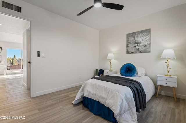 bedroom with access to exterior, ceiling fan, and light hardwood / wood-style flooring