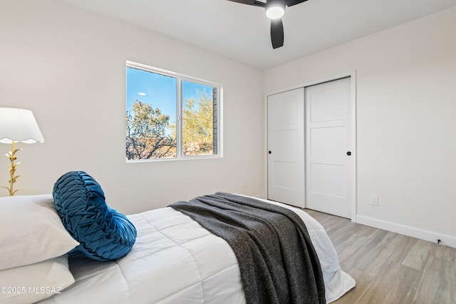 bedroom featuring ceiling fan, a closet, and light wood-type flooring