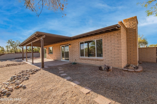 back of house with a patio