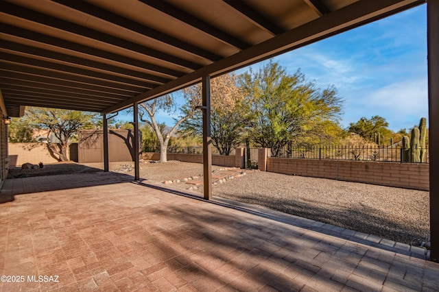 view of patio featuring a storage shed