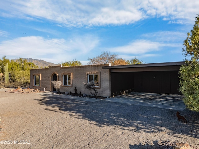 ranch-style house with a carport and a mountain view