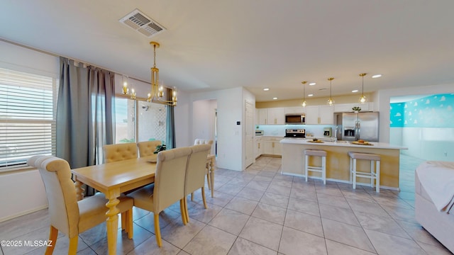 tiled dining space featuring a notable chandelier