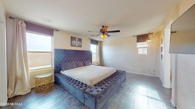 bedroom featuring ceiling fan and multiple windows