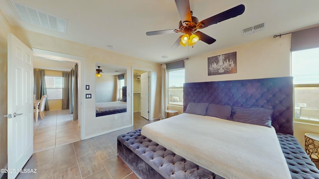 tiled bedroom featuring ensuite bath and ceiling fan