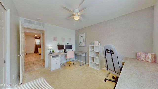 office featuring light carpet and ceiling fan