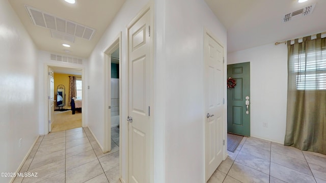 hall with light tile patterned floors