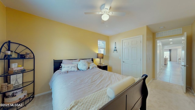 bedroom featuring light colored carpet and ceiling fan