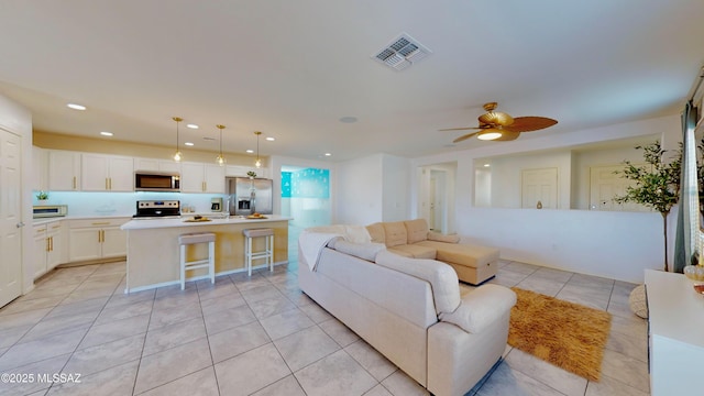 living room featuring ceiling fan and light tile patterned flooring