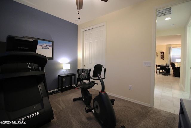 exercise room with ceiling fan and light carpet