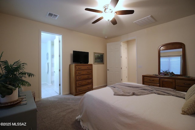 bedroom with ensuite bathroom, ceiling fan, and light colored carpet