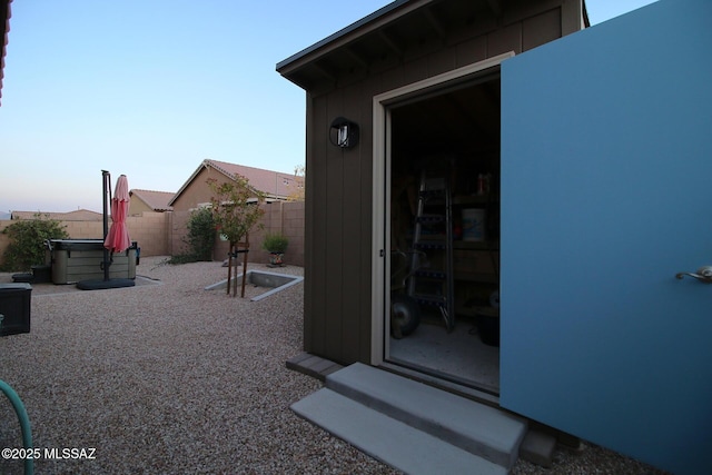 property entrance with a hot tub