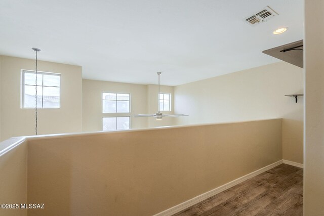 living room with a high ceiling, plenty of natural light, and ceiling fan