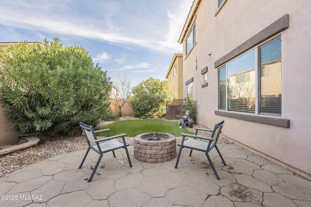 view of patio with an outdoor fire pit