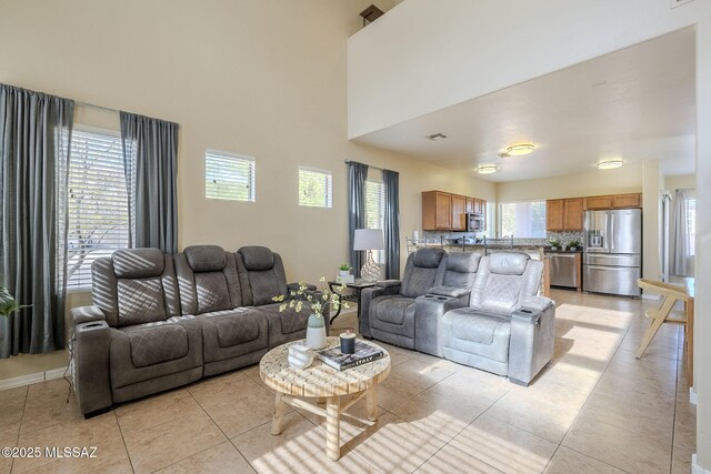 tiled living room with a towering ceiling