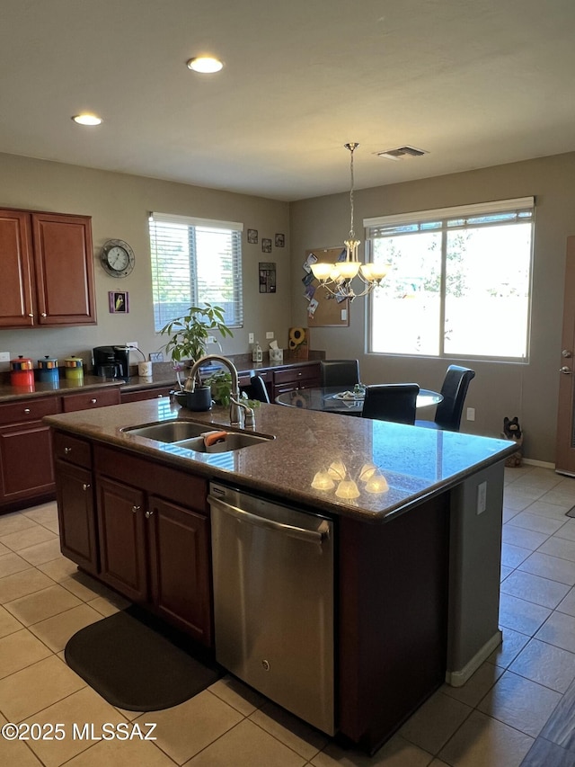 kitchen with dishwasher, sink, an inviting chandelier, a kitchen island with sink, and light tile patterned floors