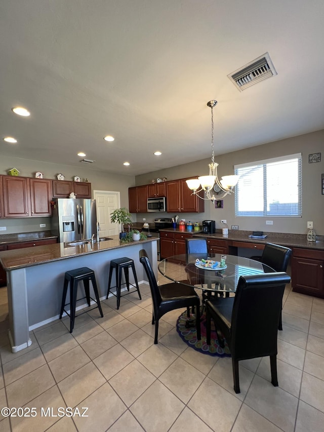 dining room featuring light tile patterned floors, visible vents, recessed lighting, and a chandelier