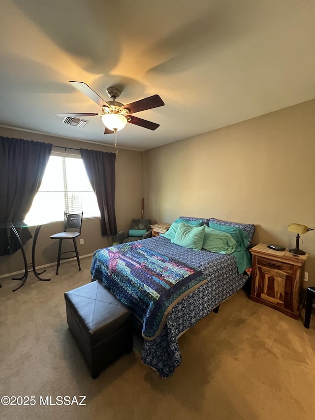 bedroom featuring visible vents, a ceiling fan, and carpet