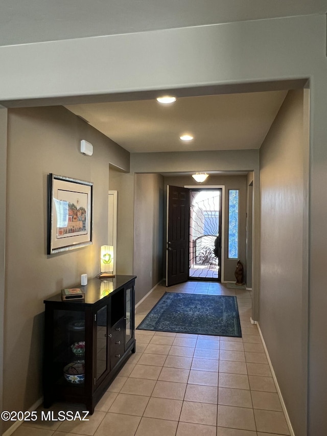 entryway featuring light tile patterned floors and baseboards