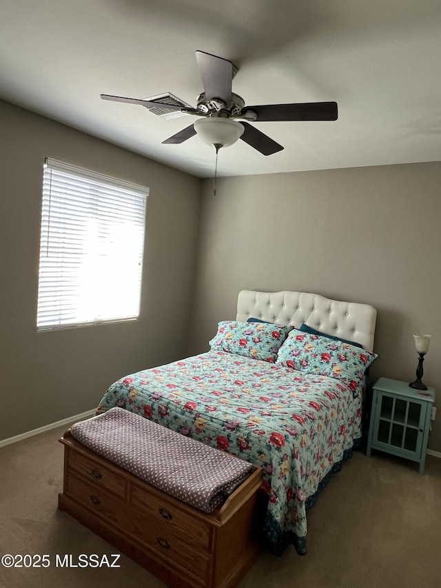 bedroom with a ceiling fan, carpet, and baseboards