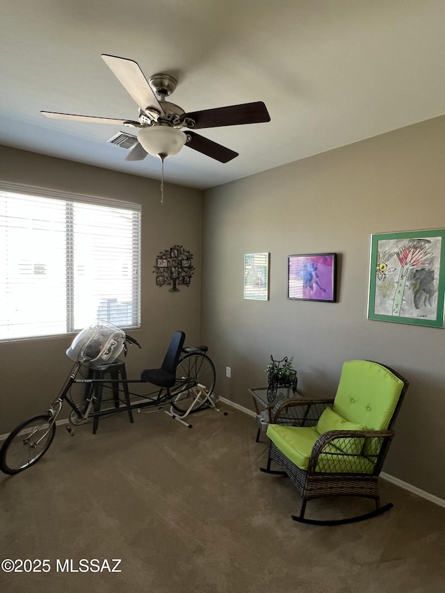 unfurnished room featuring a ceiling fan, carpet, visible vents, and baseboards