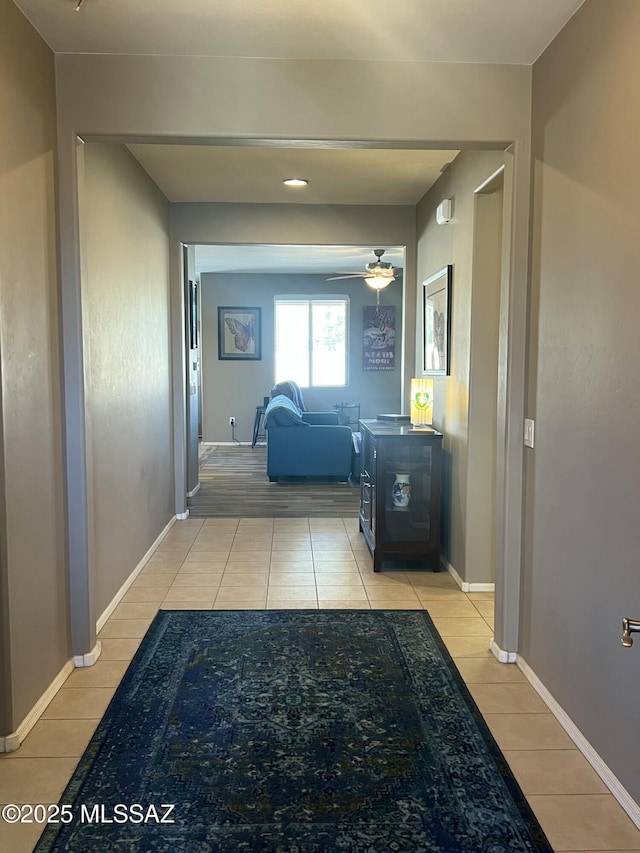 hall featuring baseboards and wood finished floors