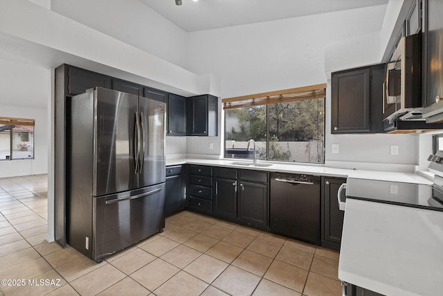 kitchen with sink, light tile patterned floors, and stainless steel appliances