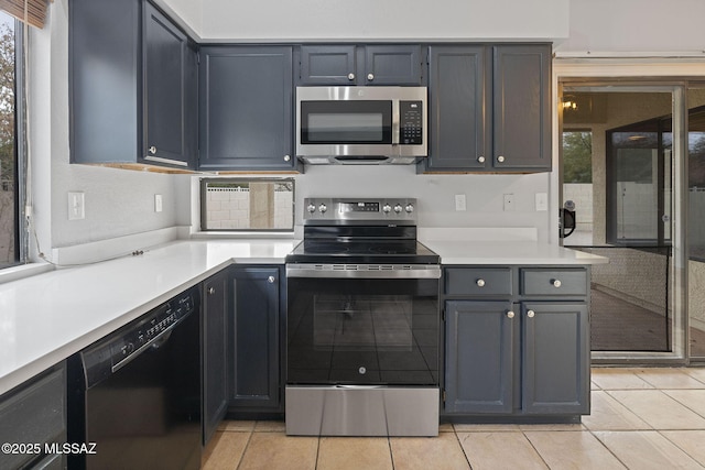 kitchen featuring light tile patterned floors and appliances with stainless steel finishes