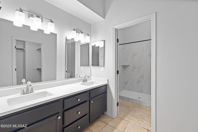 bathroom featuring vanity and tiled shower