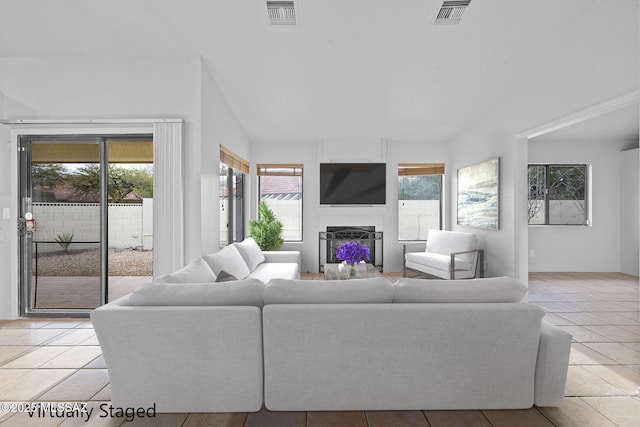 tiled living room featuring lofted ceiling