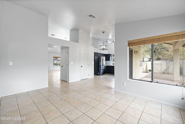 interior space with a chandelier and light tile patterned floors