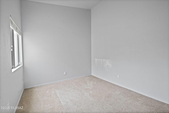 spare room featuring light colored carpet