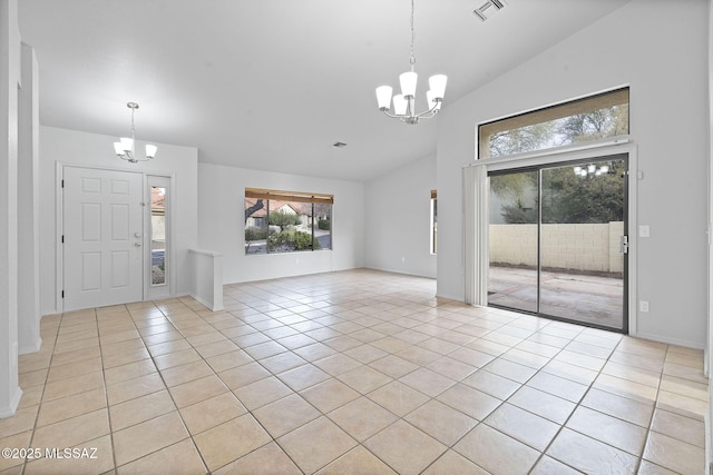 foyer entrance featuring light tile patterned floors, high vaulted ceiling, and a notable chandelier