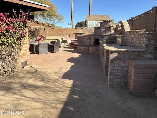 view of patio featuring exterior kitchen