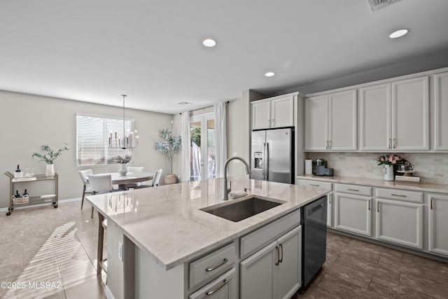 kitchen with dishwashing machine, a kitchen island with sink, sink, pendant lighting, and stainless steel fridge with ice dispenser