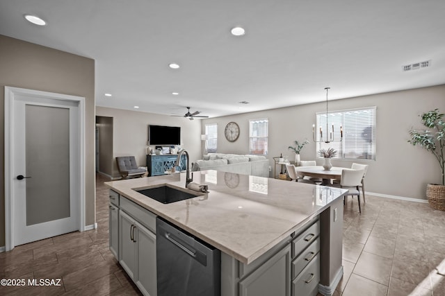 kitchen featuring stainless steel dishwasher, ceiling fan, sink, pendant lighting, and a center island with sink