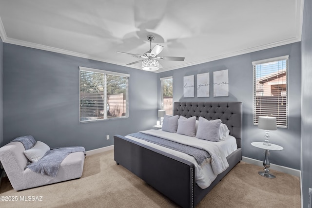 carpeted bedroom featuring ceiling fan and crown molding