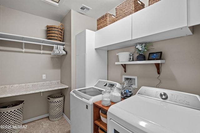 clothes washing area with washing machine and dryer