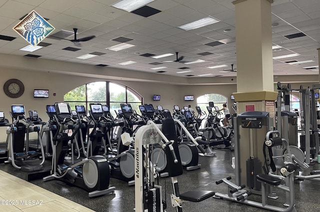 workout area with a paneled ceiling and ceiling fan