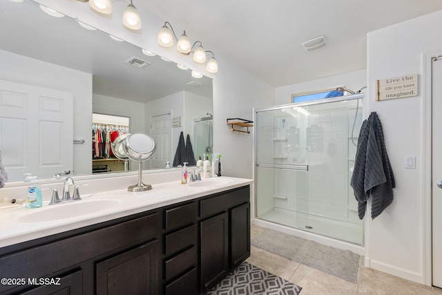 bathroom with tile patterned floors, vanity, and an enclosed shower