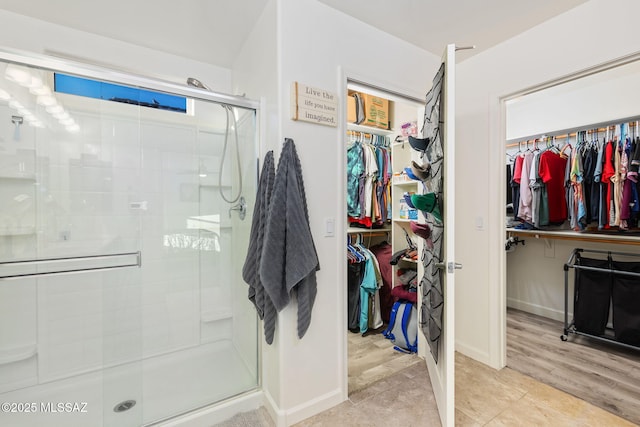 bathroom featuring a shower with door and tile patterned flooring