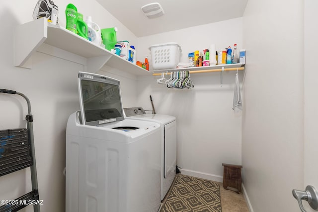 clothes washing area featuring washer and clothes dryer